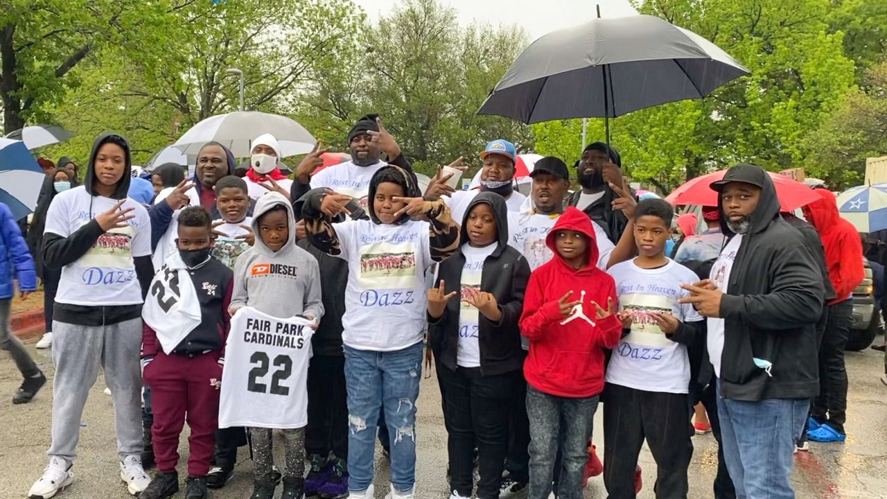 Pictured are friends and fellow football teammates of 11-year-old Dazmon Ray Brown Jr. who attended a memorial service April 15. They’re wearing shirts that read “Rest in Heaven Dazz.”  (Lupe Zapata/Spectrum News 1)